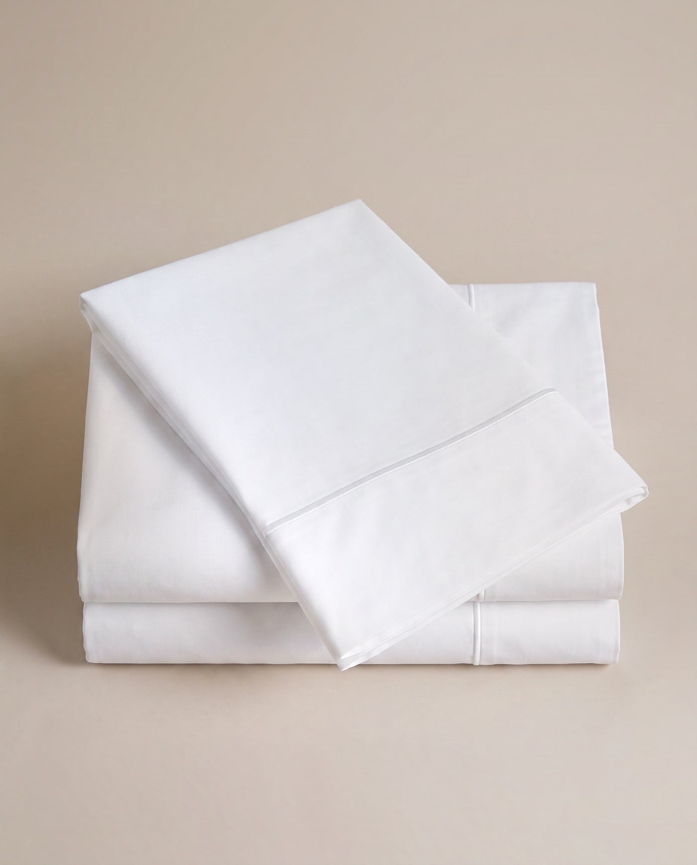 Folded white percale — smooth and hard-wearing.